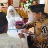 Irwan Basir Dt. Rajo Alam, SH MM saat menjadi saksi nikah pasangan Yongky Firmando dan Santi Eka Putri